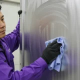 homem limpando porta de aluminio